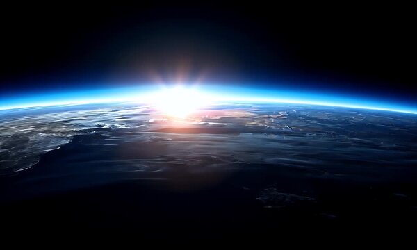 Sunrise over earth s atmosphere as seen from space with a vibrant blue glow and orange sunbeams reflecting on clouds