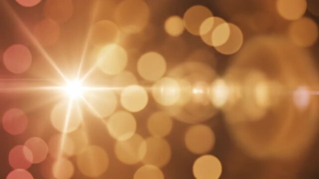 Golden bokeh lights creating warm abstract glow and lens flare in soft background.