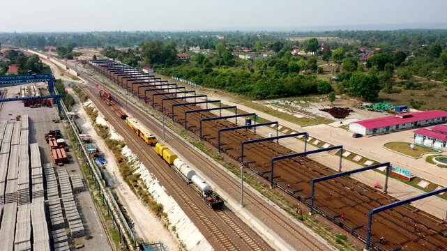 Industrial Railroad Yard with Gantry Cranes and Freight Trains