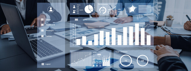 A business team engages in data analysis using digital tools in a modern office setting, showcasing graphs and charts for strategic decision-making. Axiom