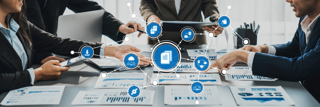 A modern office setting showcasing a diverse team engaged in strategic management discussions using digital tools, data analysis, and collaborative methodologies to enhance business efficiency. Amity - Powered by Adobe