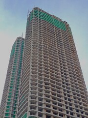 High rise building site showing multiple floors and safety netting during the development phase