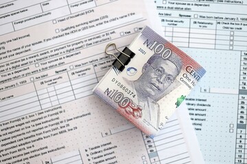 Nigerian naira money bills on tax form close up. Taxation and accounting concept