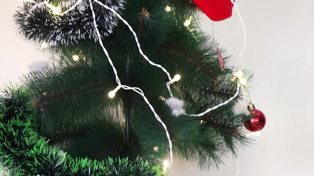 Decorated Christmas tree with cake and gifts.