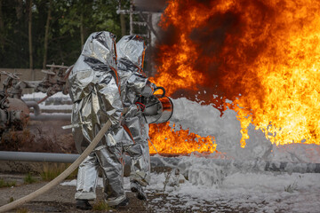 Firefighters use a foam generator to supply foam to extinguish the fire. A fire at the plant caused by the ignition of an oil product. Firefighters extinguish a fire at an oil refinery.