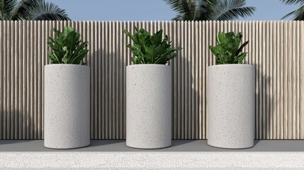 Three tall, cylindrical concrete planters filled with lush green plants, arranged in a row against a wooden fence backdrop.