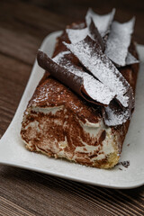 Tiramisu Tronchetto Dessert, Italian Yule Log Christmas dessert with chocolate bark, High quality photo