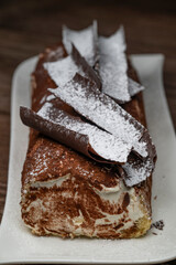 Tiramisu Tronchetto Dessert, Italian Yule Log Christmas dessert with chocolate bark, High quality photo