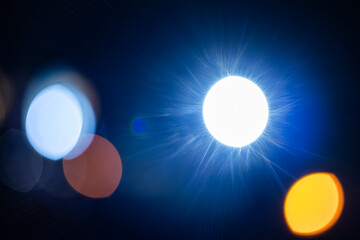Abstract blue and orange bokeh lights on dark background