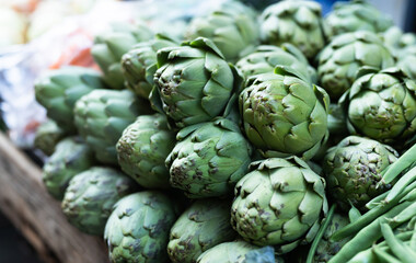 Pile of artichokes displayed on market counter