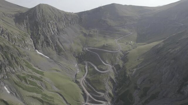 Aerial view of the winding mountain road over Abano Pass in Tusheti, Georgia, known as one of the worlds most dangerous high-altitude routes. High-quality aerial footage.