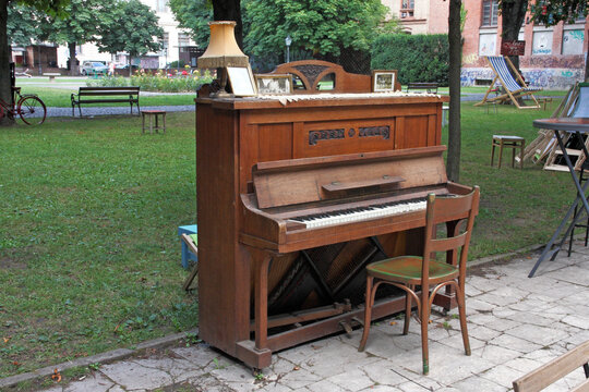An antique piano from the early 20th century waiting for its performer in the park