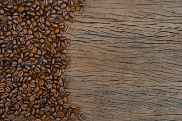  top view of coffee beans on a rustic wooden floor. Copy space
