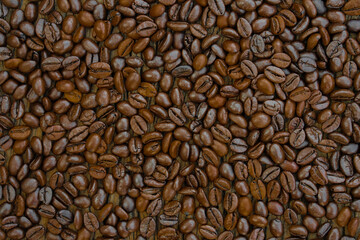Top view of a background or texture of roasted coffee beans.