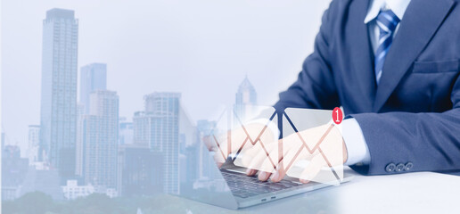 Businessman typing on laptop with email notification icon corporate communication and online messaging concept digital inbox alert business technology professional email marketing over city background