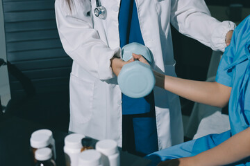 Physical therapist assisting a woman with dumbbell exercise
