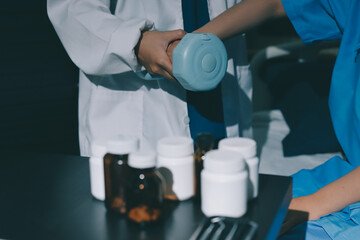 Physical therapist assisting a woman with dumbbell exercise