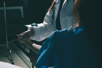 Doctor examining patient's elbow in hospital room