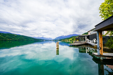 View of Lake Millstatt and the surrounding green landscape. Idyllic nature by the lake north of the Drava Valley near the town of Spittal an der Drau in Carinthia.
