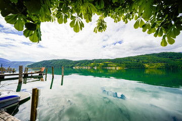 View of Lake Millstatt and the surrounding green landscape. Idyllic nature by the lake north of the Drava Valley near the town of Spittal an der Drau in Carinthia.
