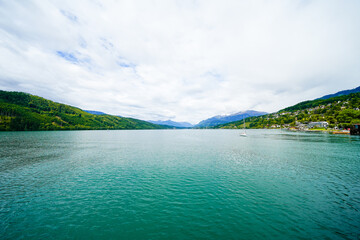 View of Lake Millstatt and the surrounding green landscape. Idyllic nature by the lake north of the Drava Valley near the town of Spittal an der Drau in Carinthia.
