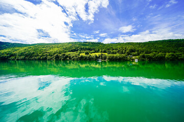 View of Lake Millstatt and the surrounding green landscape. Idyllic nature by the lake north of the Drava Valley near the town of Spittal an der Drau in Carinthia.
