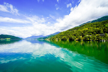 View of Lake Millstatt and the surrounding green landscape. Idyllic nature by the lake north of the Drava Valley near the town of Spittal an der Drau in Carinthia.

