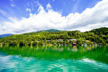 View of Lake Millstatt and the surrounding green landscape. Idyllic nature by the lake north of the Drava Valley near the town of Spittal an der Drau in Carinthia.
