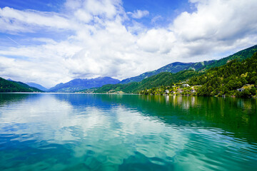 View of Lake Millstatt and the surrounding green landscape. Idyllic nature by the lake north of the Drava Valley near the town of Spittal an der Drau in Carinthia.

