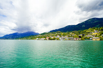 Fototapeta premium View of Lake Millstatt and the surrounding green landscape. Idyllic nature by the lake north of the Drava Valley near the town of Spittal an der Drau in Carinthia. 