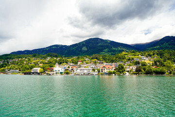 View of Lake Millstatt and the surrounding green landscape. Idyllic nature by the lake north of the Drava Valley near the town of Spittal an der Drau in Carinthia.
