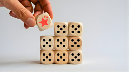 Hand placing a dice with a red star on top of a grid of other dice, symbolizing strategy and decision-making