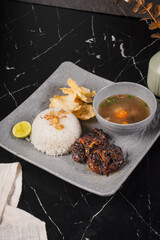 Traditional Indonesian Breakfast Meal with Rice and Soup.
