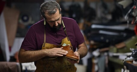Skilled Shoemaker Meticulously Examines a Handmade Leather Brogue Shoe in His Traditional Workshop