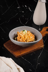 Bowl of Pasta on Wooden Board.