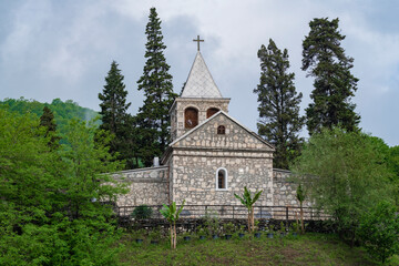 View of the ancient church of St. John Chrysostom on a cloudy May day. Kaman monastery. Kamani, Abkhazia