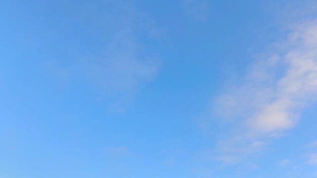 Orange cirrus clouds moving across the sky at the start of the day