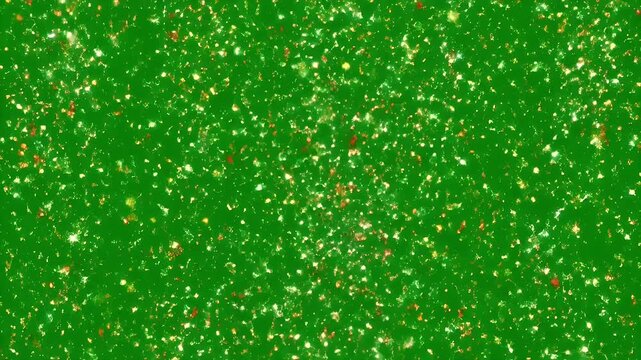 Green Glitter Texture - This is a macro shot showing a vibrant green background covered with gold and white glitter. The shiny particles reflect light, creating a sparkly and festive effect.