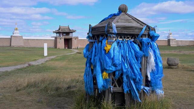 Sacred blue scarves fluttering in the wind at the Erdene Zuu temple complex in Kharkhorin, Mongolia. Traditional Buddhist offerings on the steppe.