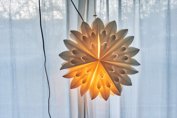 A paper Christmas star in the window.