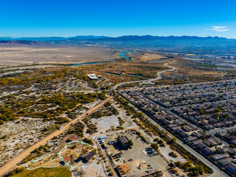 Aerial view of suburban residential neighborhoods and arterial roads in Los Angeles under clear blue sky