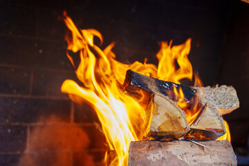 Fire burns wood in fireplace during evening hours