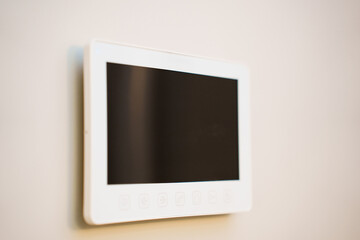 Smart device mounted on a wall in a modern room
