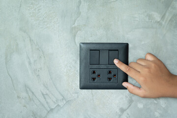 hand holding a light switch