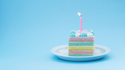 Colorful cake and a candlelight on a blue background.
