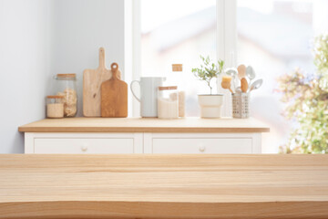 Wooden tabletop over defocused rustic kitchen counter background for product display and promotion