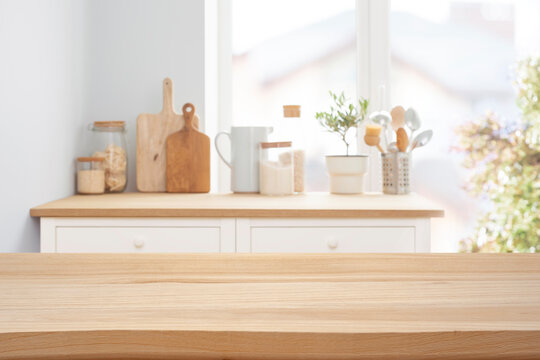 Wooden tabletop over defocused rustic kitchen counter background for product display and promotion