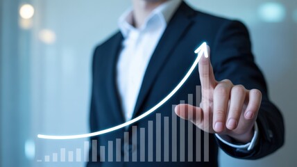 Businessman pointing at a virtual glowing arrow chart showing growth and success.