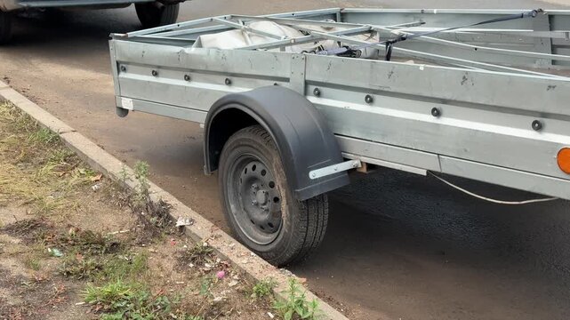 Closeup Of Worn Trailer Parts, Detail View Of Aged Trailer With Rusted Components And Hitch, Close Examination Of Weathered Trailer Showing Corroded Parts And Wornout Taillight