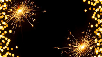 Vibrant sparklers shining brightly in dark night with glowing bokeh lights